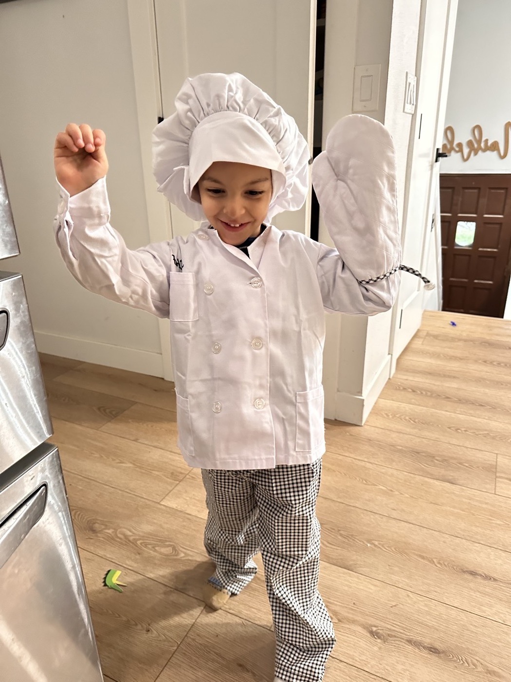 One of the kids in a full chef costume